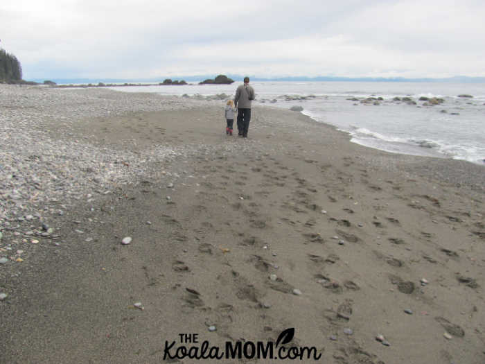 Dad and daughter walking down the beach. Photo by Bonnie Way.