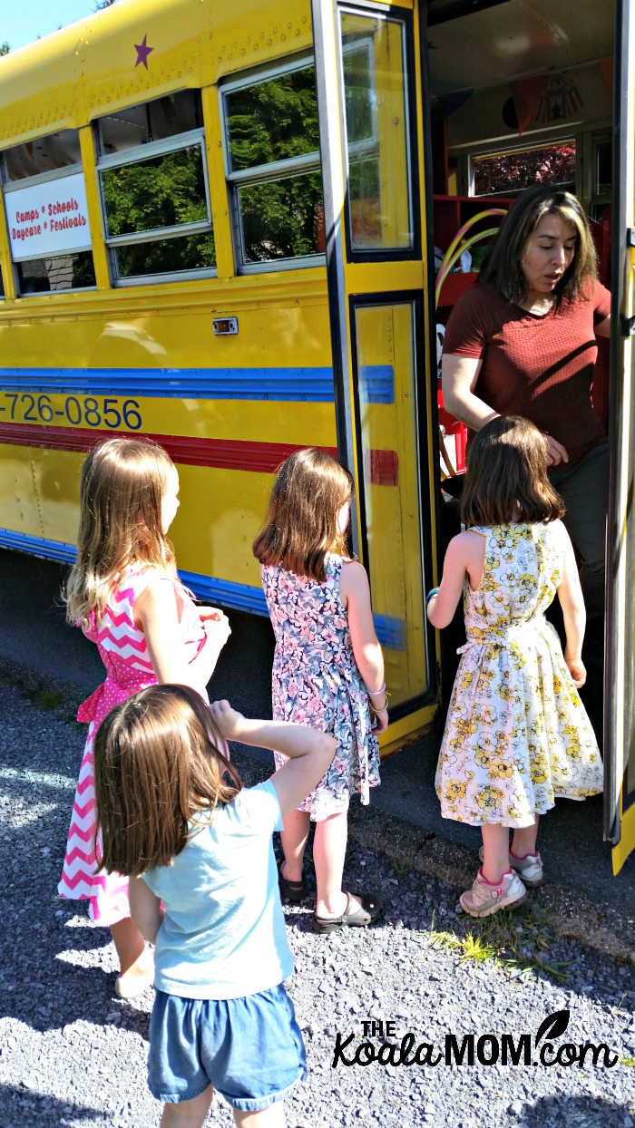 All aboard the Vancouver Tumblebus! Children at a GymBus birthday party line up to play on the bus.
