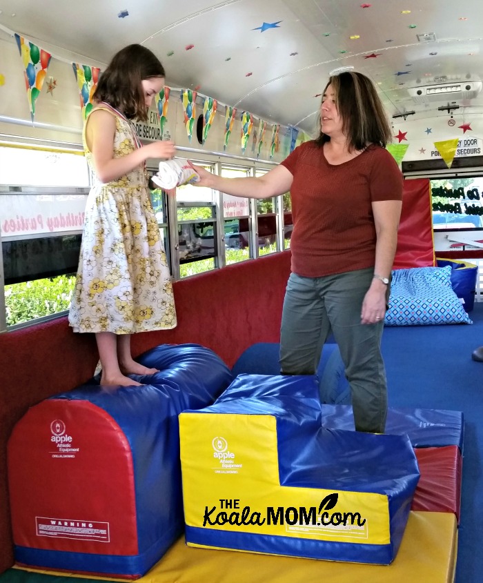 The birthday girl gets a medal and T-shirt on the Tumblebus!