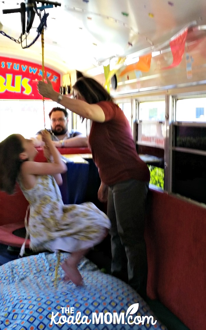 Lily swinging on the Tumblebus