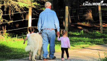 Girls walking the dog with Grandpa.