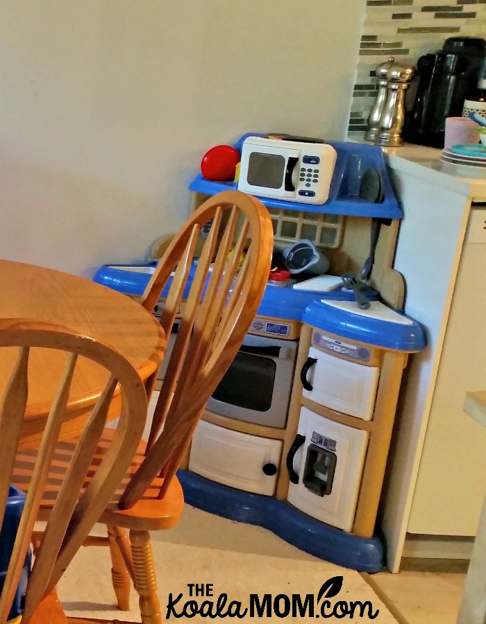 A toddler kitchen in the corner of our kitchen and dining room