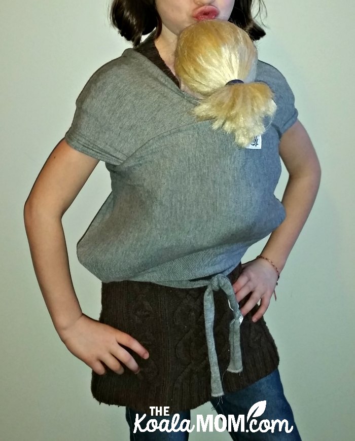 Seven-year-old girl wearing her 18-inch doll in a Beluga Baby bamboo doll wrap