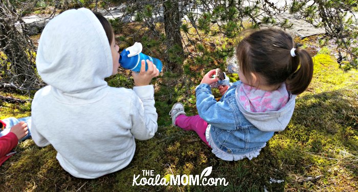Two girls enjoying snacks at Nairn Falls.