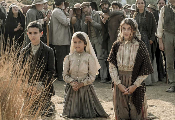 Lucia Santos and Jacinta and Francisco Marto kneel before Our Lady.