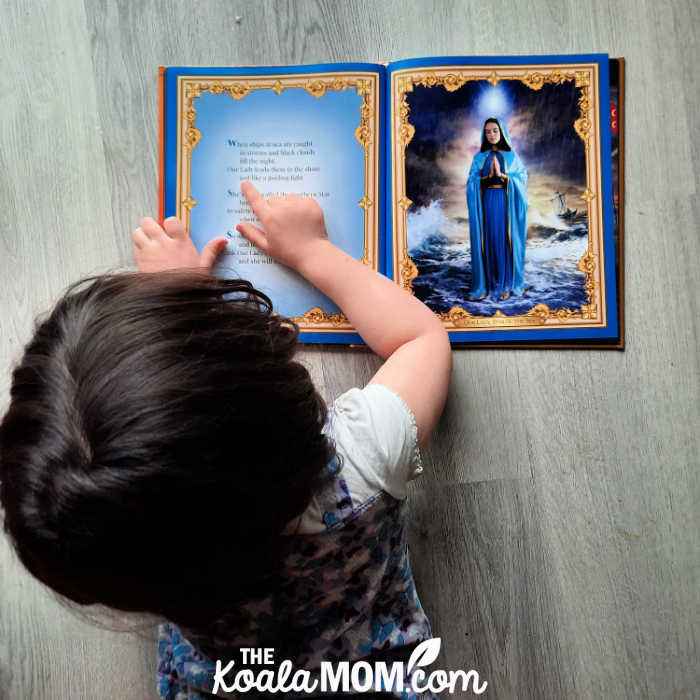 5-year-old Pearl reading Our Lady's Picture Book by Anthony DeStefano