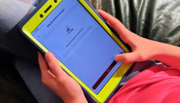 11-year-old playing the money trivia games in the Mydoh app.