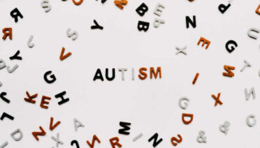 Scattered letters of the alphabet, spelling AUTISM. Photo by Annie Spratt on Unsplash