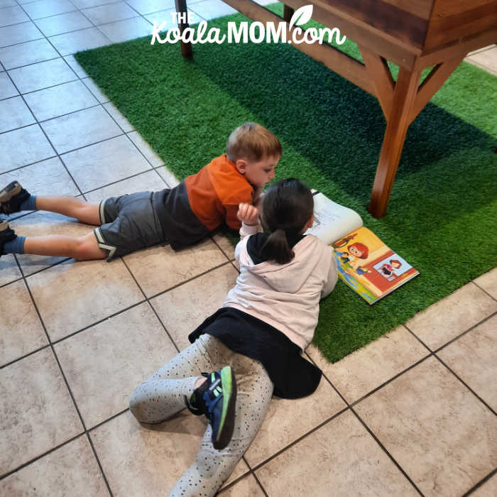 Kids reading a book about sasquatches at the Harrison Visitor Centre.