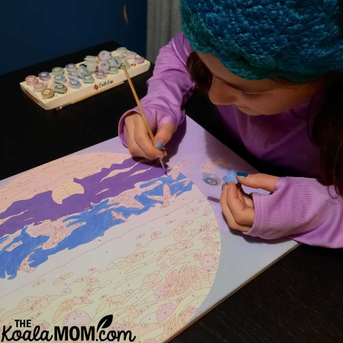 Teen painting by number.