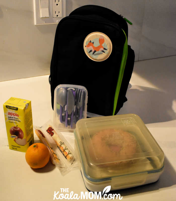 School lunch ready to be packed in a small black-and-green lunch bag.