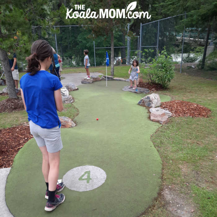 Girl golfing at Howling Wolf Mini-Golf in Panorama, BC.