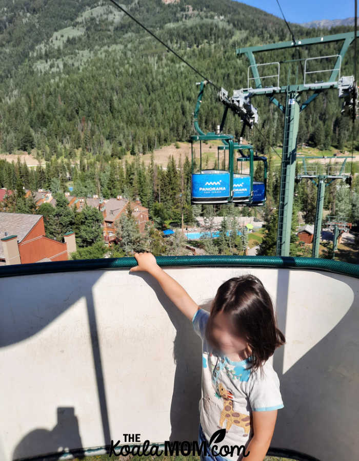 Girl riding in the Panorama village gondola.