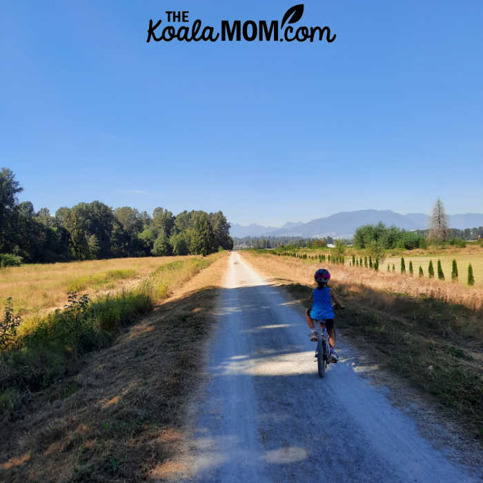 Girl riding along the dike trails in Maple Ridge and Pitt Meadows.