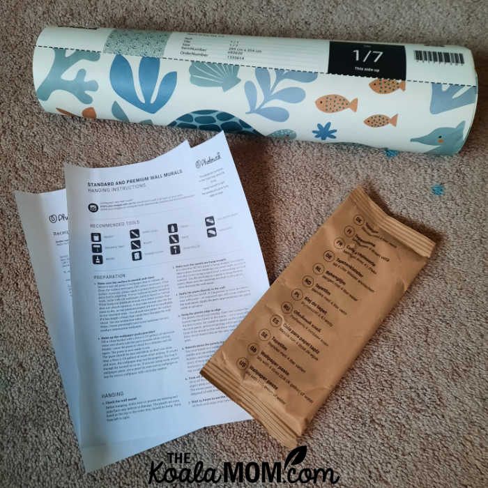 A roll of Photowall wallpaper, with instructions and paste.