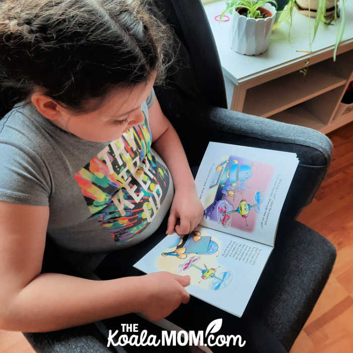 Girl reads Lynn Johnston's book A Little Kindness in her Alottabotz series.