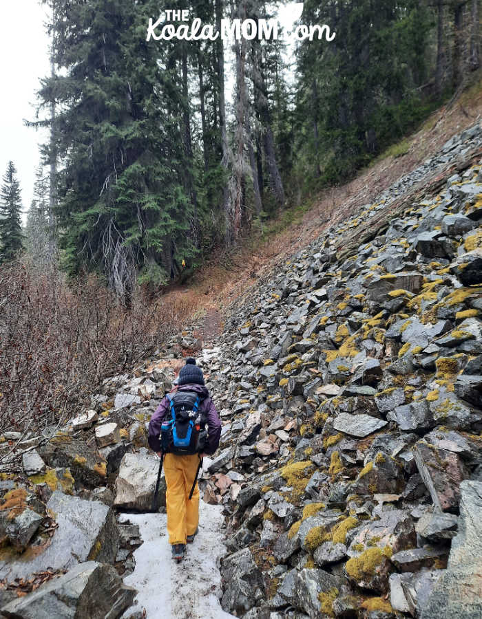 8-year-old hiking over a patch of snow on the Strike Lake Trail in Manning Park.