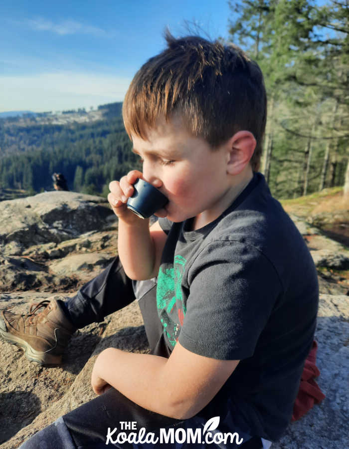 Boy enjoys his small cup of tea while outdoors. Photo by Bonnie Way.