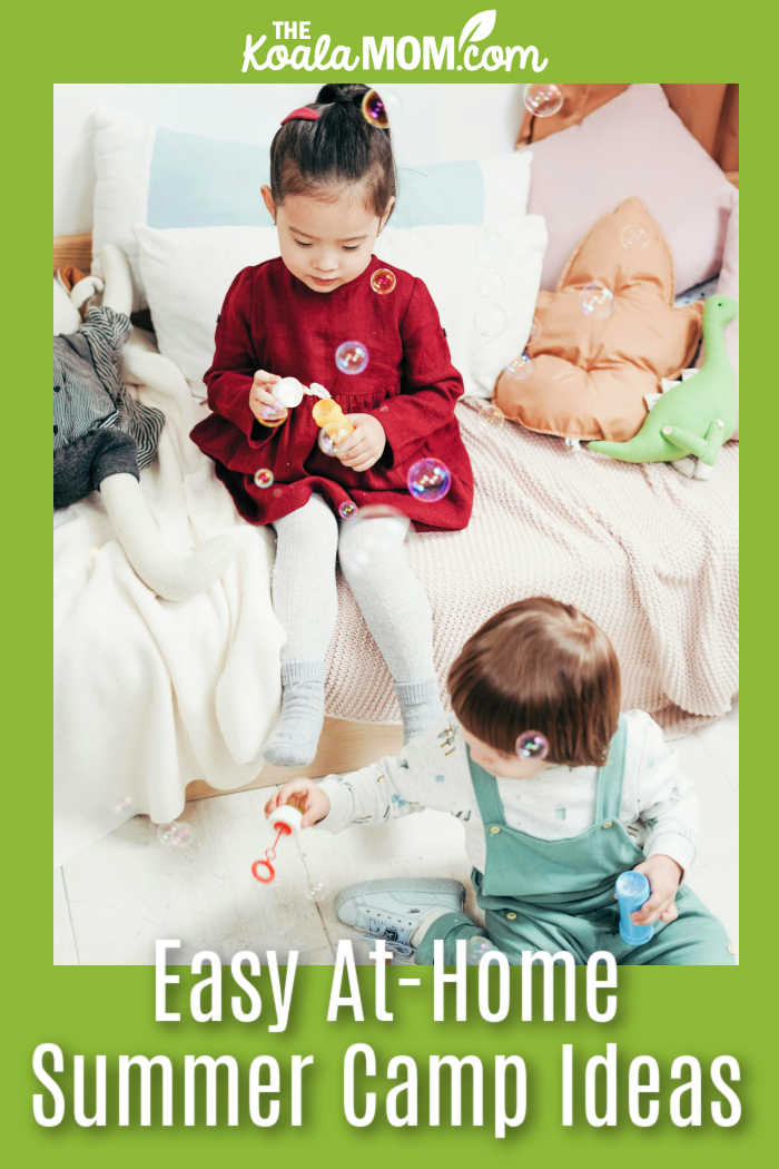 At-Home Summer “Camp” Ideas Parents Can Actually Keep Up With. Photo of sisters sitting on a bed blowing bubbles together by cottonbro studio via Pexels.