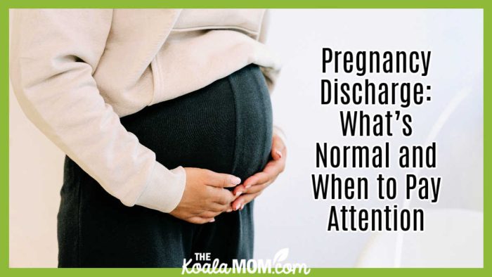 Pregnancy Discharge: What’s Normal and When to Pay Attention. Photo of woman wearing black pants and a white sweatshirt with her hands cupped under her pregnant tummy by Ivan S via Pexels.