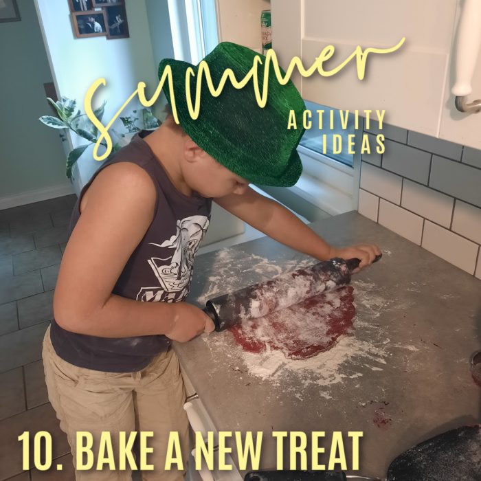 summer activity ideas. 10. Bake a new treat. Photo of a boy rolling out red cookie dough by Bonnie Way.