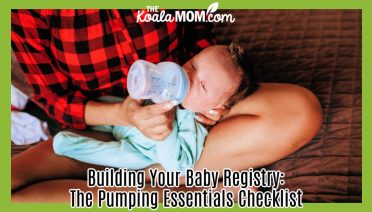 Building Your Baby Registry: The Pumping Essentials Checklist. Photo of a mom wearing a red and black checked shirt and sitting cross-legged with baby on her legs drinking a bottle by Helena Lopes via Pexels.
